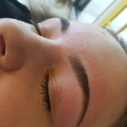 Close-up of a client’s shaped and tinted eyebrow, photographed while they lie back on the treatment couch
